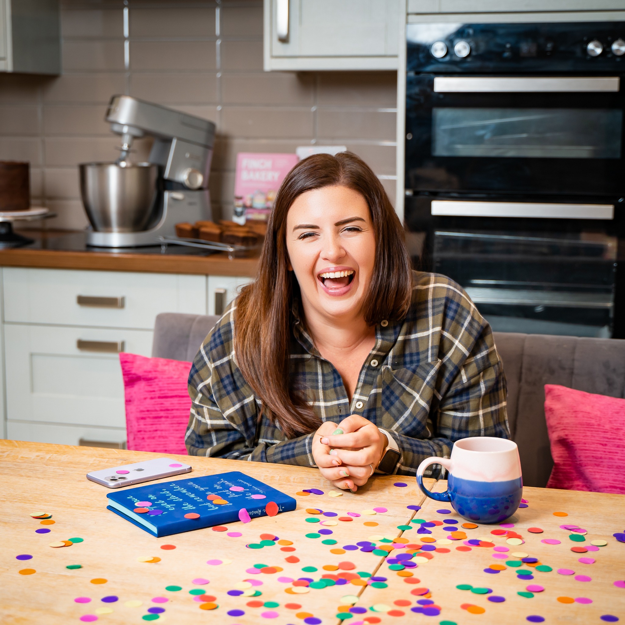 charlotte dodds a business baker consultant laughing at the end of her personal brand photoshoot after blowing confetti in her home near wrekenton with personal brand photographer Zoe Campbell newcastle upon tyne