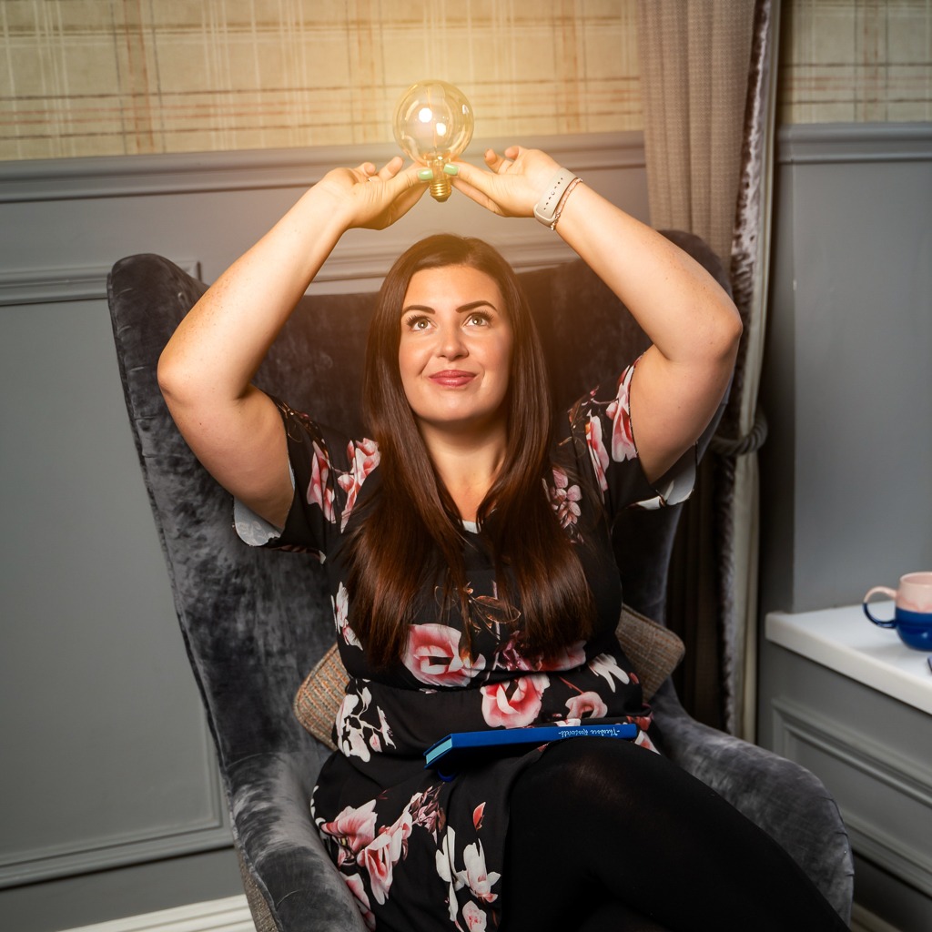 business baker consultant, having a personal brand photoshoot, holding a light bulb, personal brand photo idea with zoe campbell personal brand photographer based in newcastle upon tyne